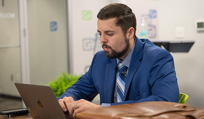 Photo of a man working on a laptop at Gig East