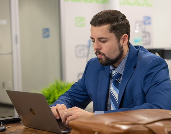 Photo of a man working on a laptop at Gig East