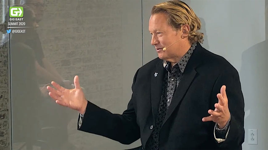 Video still of a man talking and wearing a headset
