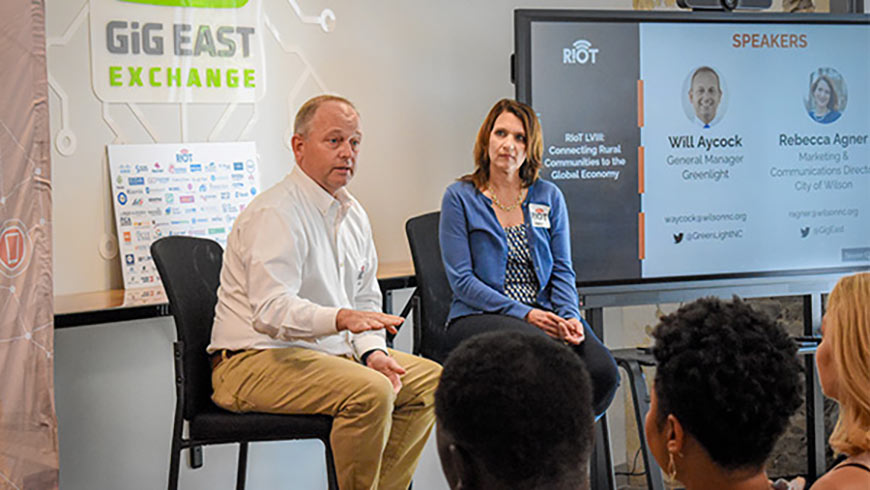 Photo of Will Aycock and Rebecca Agner speaking to an audience at the first Gig East Exchange event