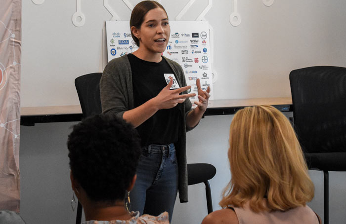 Photo of a woman speaking in front of an audience